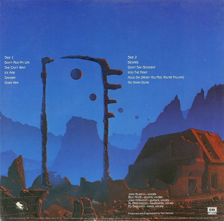 Front and back jacket illustration presented side by side. On the left, S•P•Y•S fills the bloody sun hanging in the sky. On the right, wraparound cover art further designs the scene with a squared arch in ruins as a succession of orbs trail across the sky, the structures that line the street are broken and a rundown building on the right is in decay.