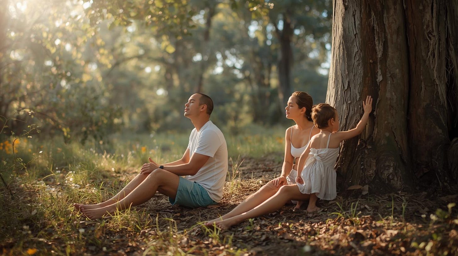 man, woman and child sit in sunlight in Australian bush man, woman and child sit in sunlight in Australian bush