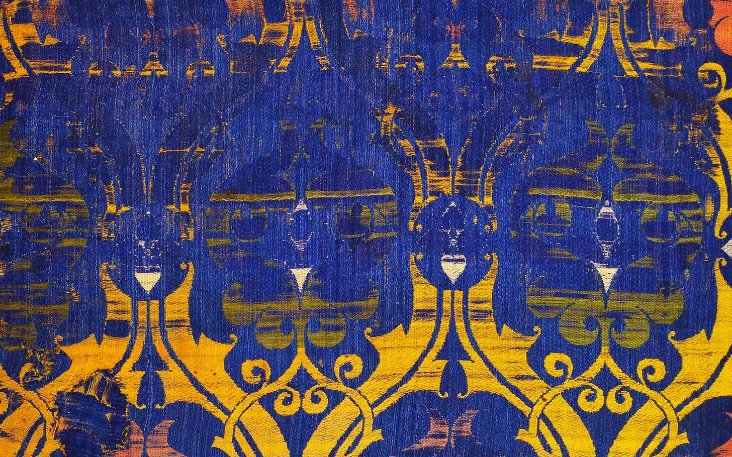 Photograph shows a close up of a patterned fabric in yellow and blue Photograph shows a close up of a patterned fabric in yellow and blue