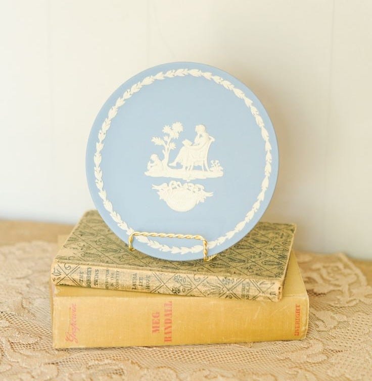 This may contain: a plate sitting on top of two books This may contain: a plate sitting on top of two books