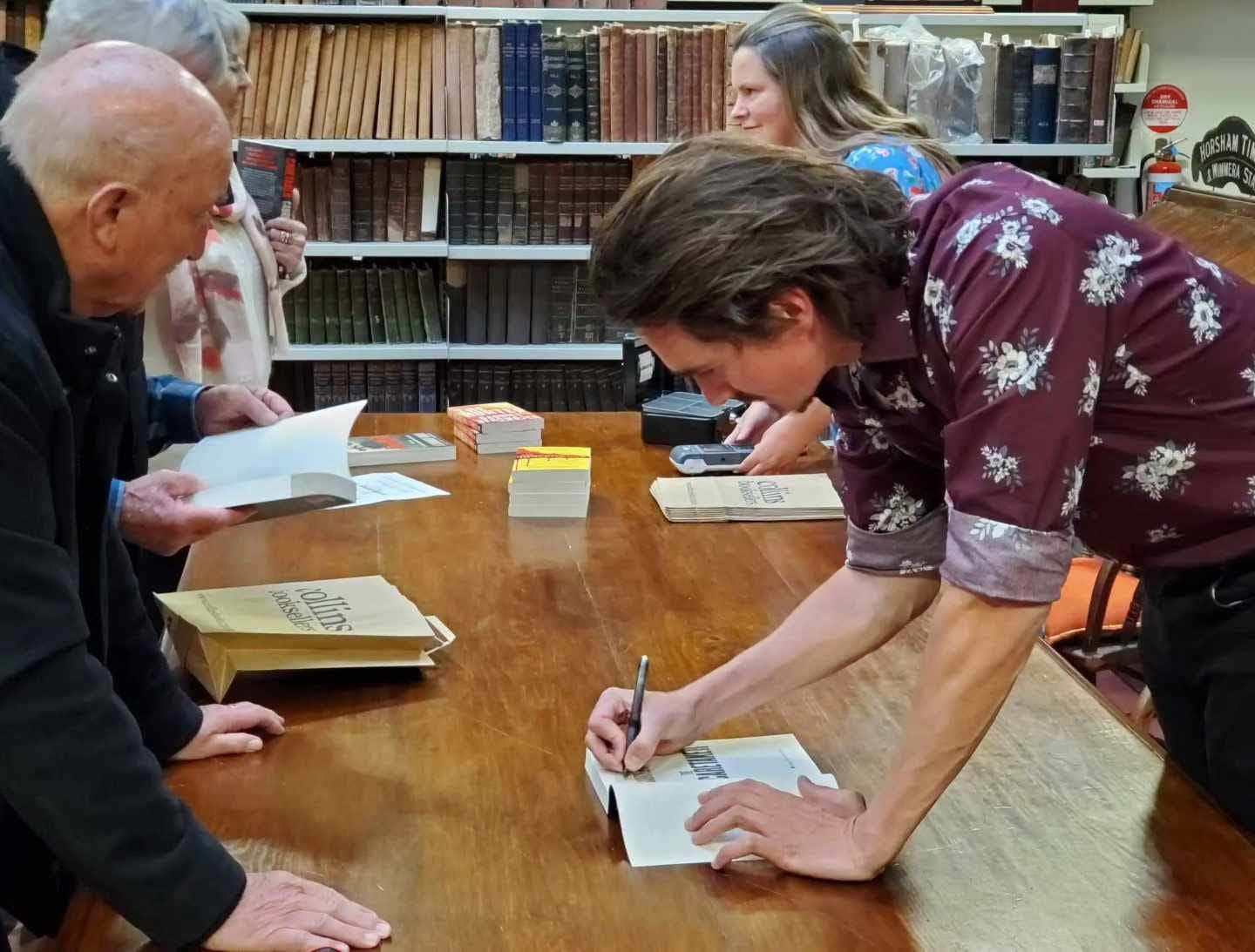 May be an image of 2 people, people studying, book and text