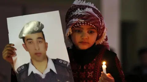 Reuters A Jordanian girl holds a poster of pilot Muath al-Kasaesbeh