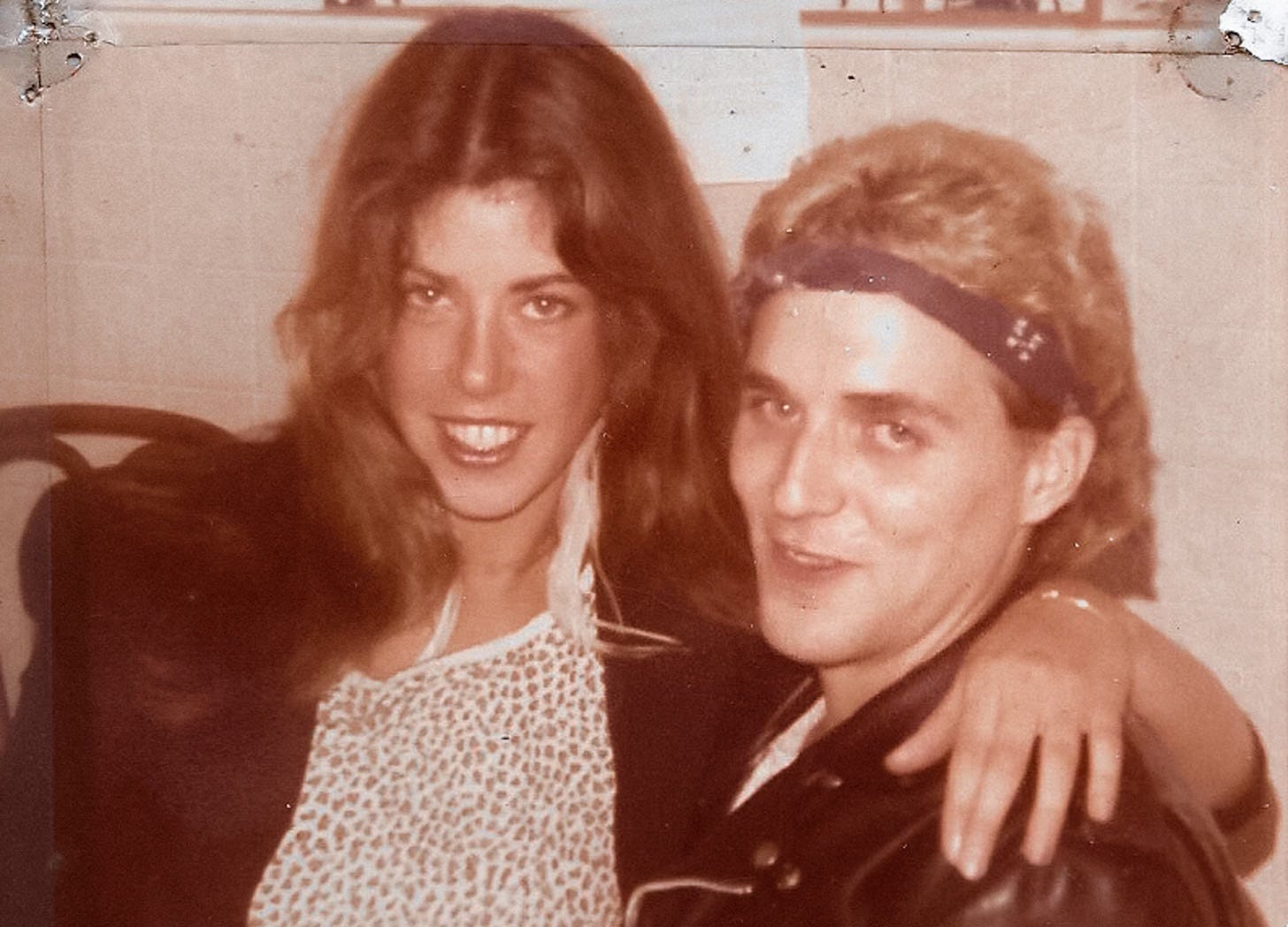 young woman with her arm around young man both smiling young woman with her arm around young man both smiling