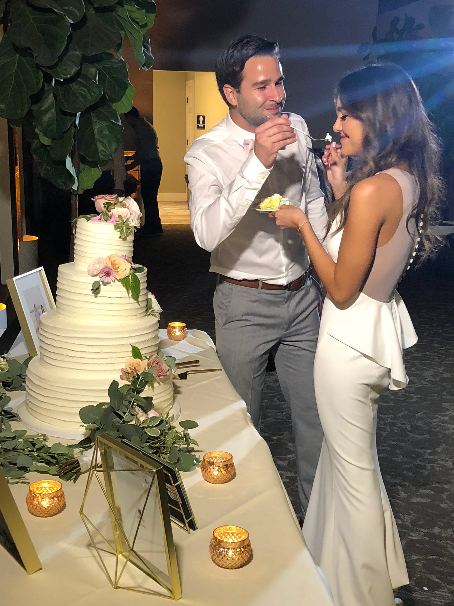 Erin and Andrew eating cake during their wedding at Calamigos Ranch in July 2018.