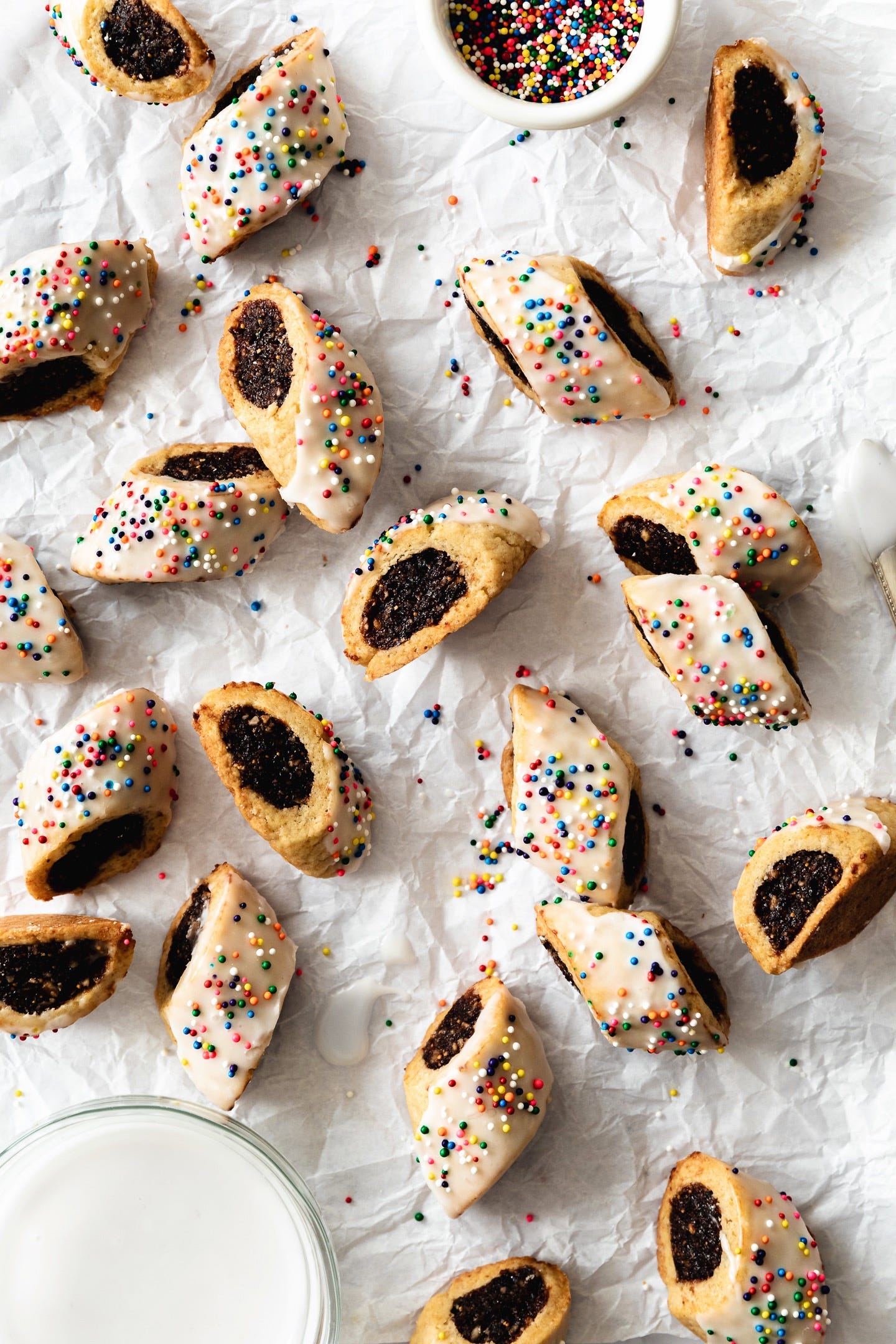 Vegan Italian fig rolls with sprinkles on white parchment paper