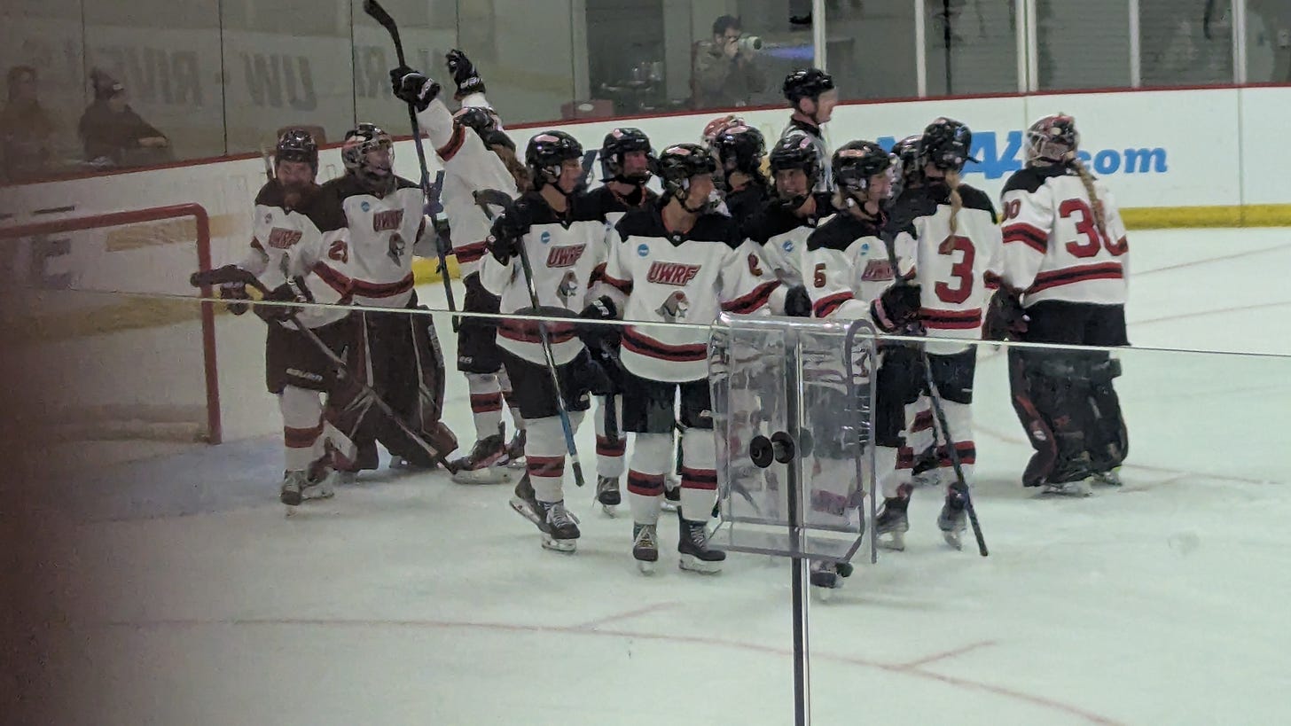 Group of UWRF players goes to hug its goaltender