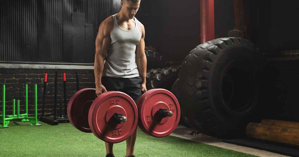 Man doing farmers walk exercise in the gym