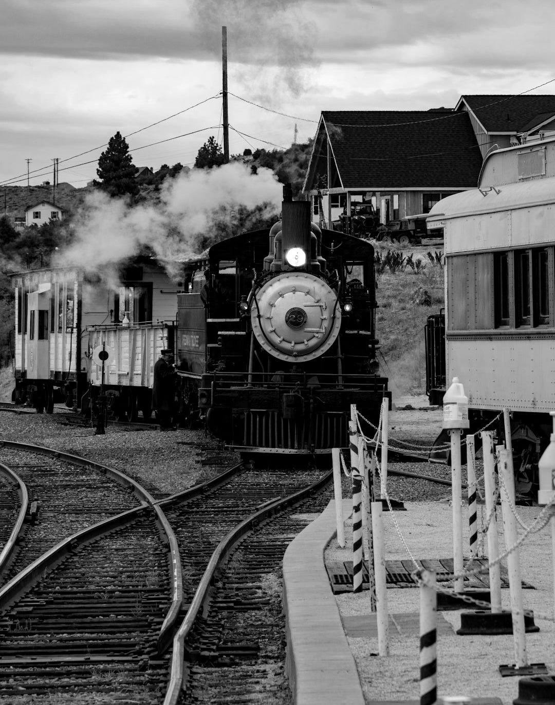 a train traveling down train tracks next to a building