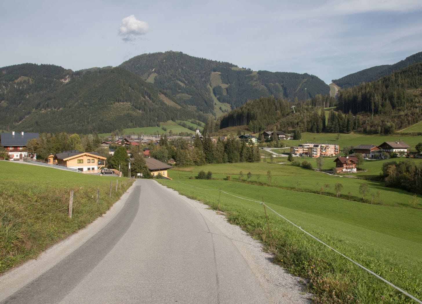 Road leading into the village of Werfenweng, Austria, showing the quiet arrival into a mountain destination Road leading into the village of Werfenweng, Austria, showing the quiet arrival into a mountain destination
