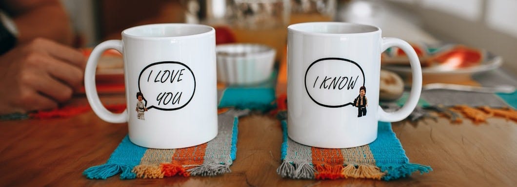 white and brown ceramic mug on blue and white textile white and brown ceramic mug on blue and white textile
