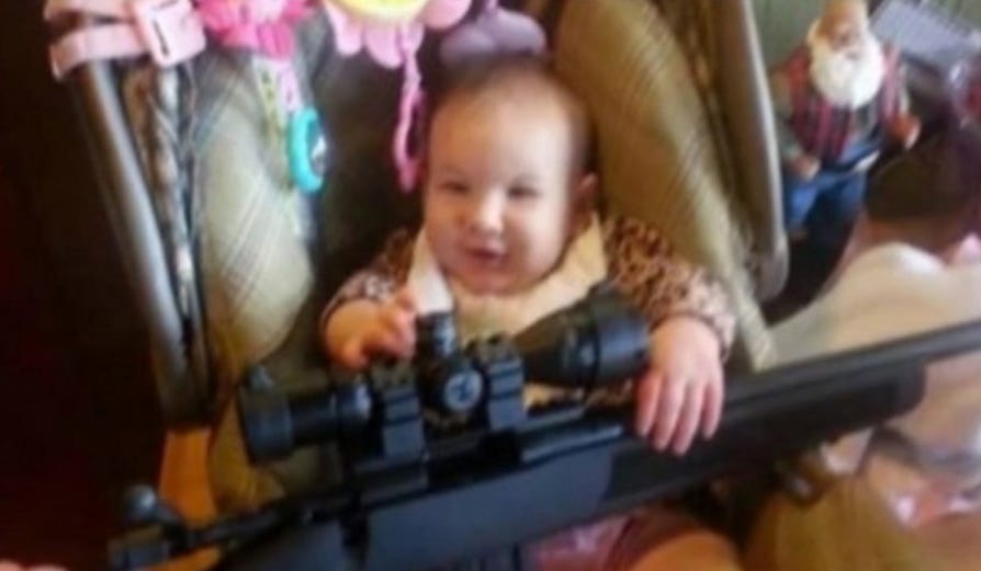 Photo Of Baby Holding Gun - Business Insider