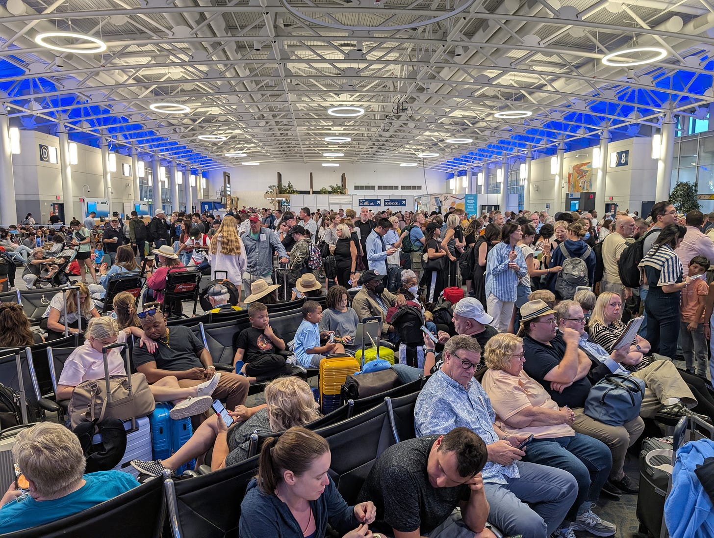 Crowded airport terminal filled with random travelers