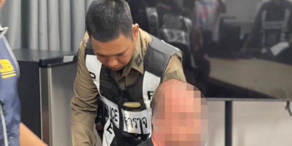 Thai official dealing with a prisoner