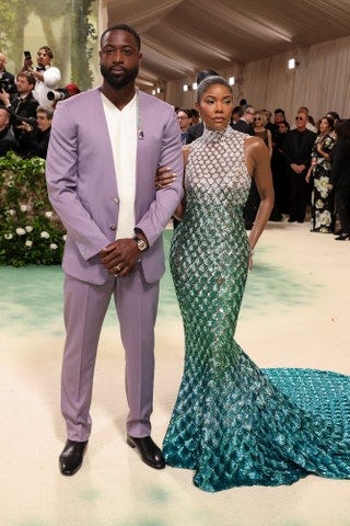 Image may contain Dwyane Wade Gabrielle Union Blazer Clothing Coat Jacket Adult Person Wedding and Wristwatch