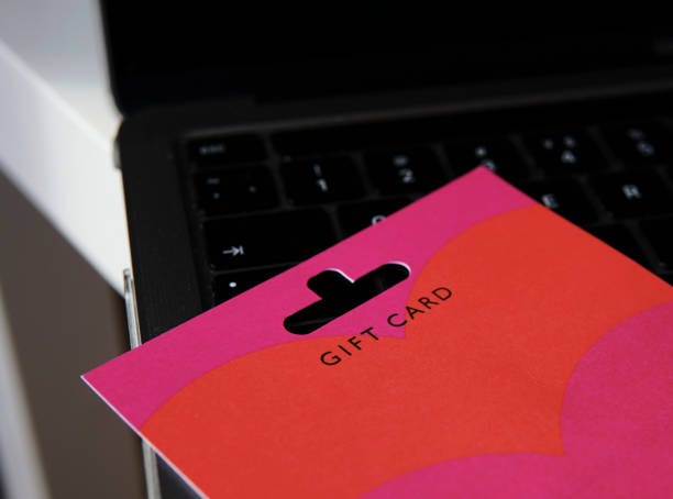 Gift Card on Laptop Keyboard for Online Shopping Concept A vibrant gift card placed on a laptop keyboard, symbolizing online shopping and digital gifting ideas. Ideal for e-commerce themes and gift-related promotions. retail store gift cards stock pictures, royalty-free photos & images Gift Card on Laptop Keyboard for Online Shopping Concept A vibrant gift card placed on a laptop keyboard, symbolizing online shopping and digital gifting ideas. Ideal for e-commerce themes and gift-related promotions. retail store gift cards stock pictures, royalty-free photos & images