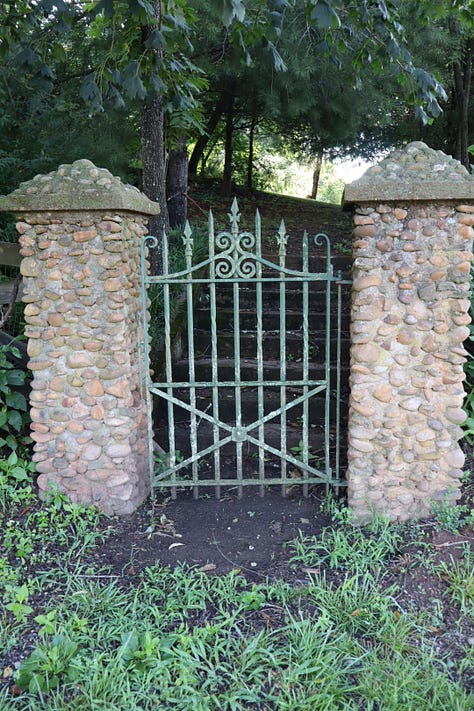 A road sign, a house number, a gate with stone pillars, a parlor with books and piano, a bedroom with writing desk