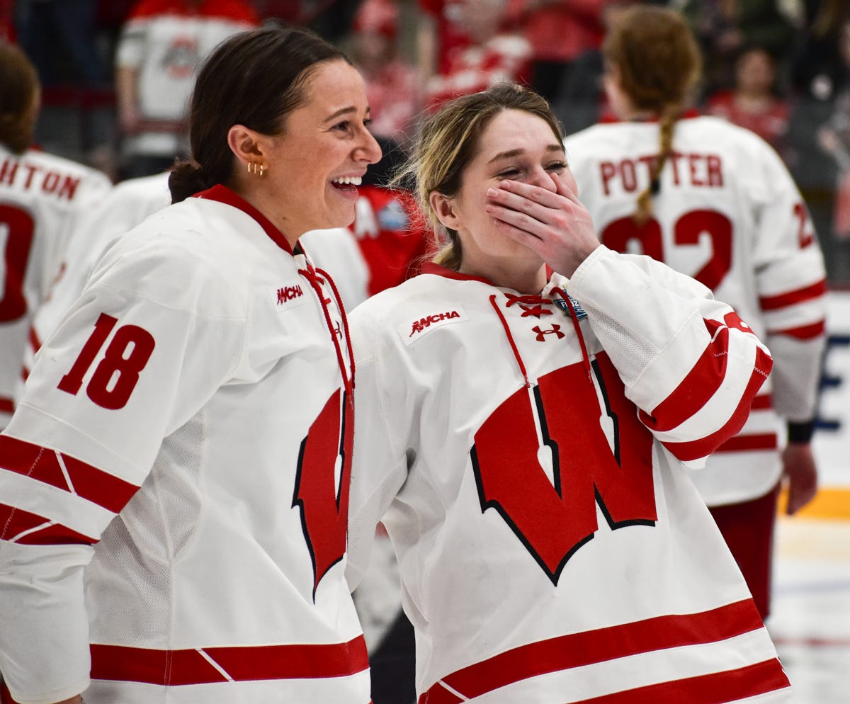 Picard and O'Brien standing without helmets after the game on the ice