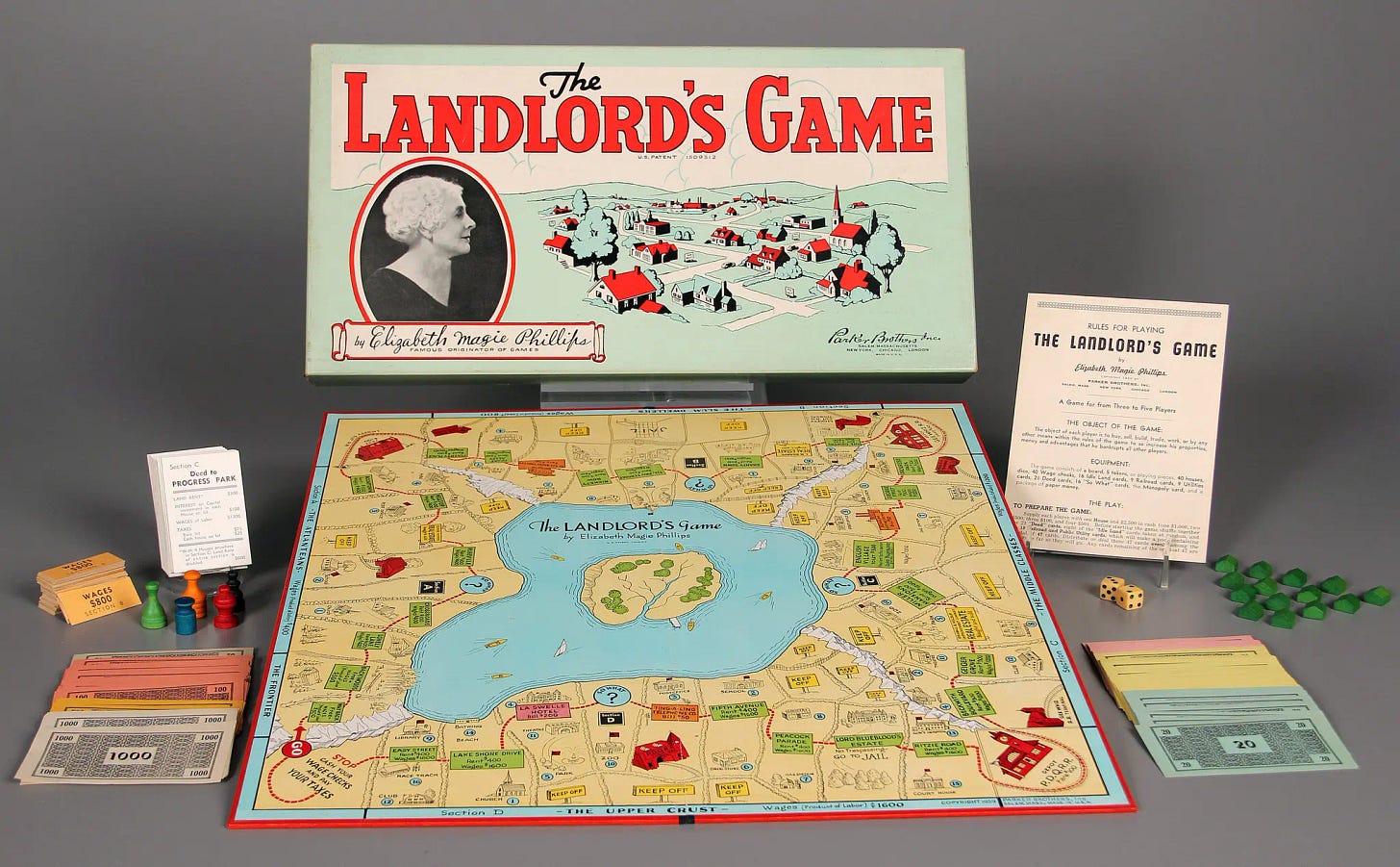 The Landlord's Game board game by Elizabeth Magie Phillips, published by Parker Brothers — the direct precursor to Monopoly — shown with its full game set including board, money, deed cards, tokens, and dice.