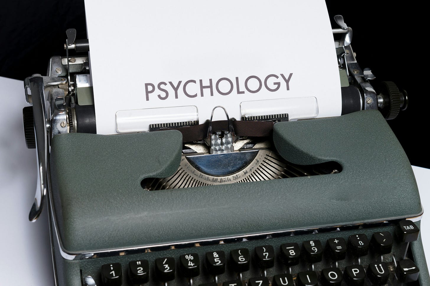 A picture of a typewriter with the word "psychology" typed onto the paper in large letters. A picture of a typewriter with the word "psychology" typed onto the paper in large letters.