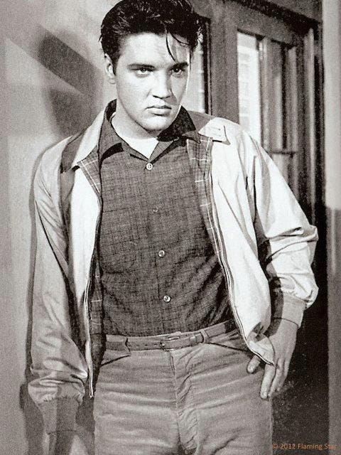 This may contain: an old photo of a young man with his hands in his pockets This may contain: an old photo of a young man with his hands in his pockets