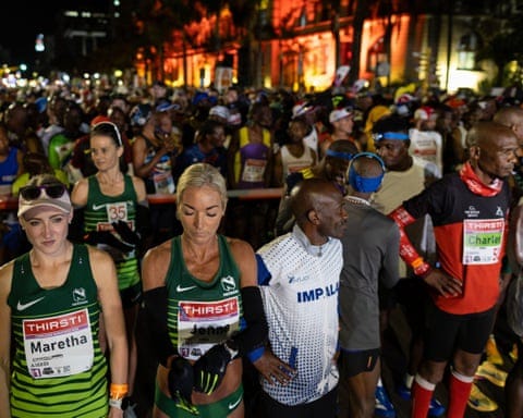 Athletes gather in the dark before the start of the Comrades Marathon in Durban Athletes gather in the dark before the start of the Comrades Marathon in Durban
