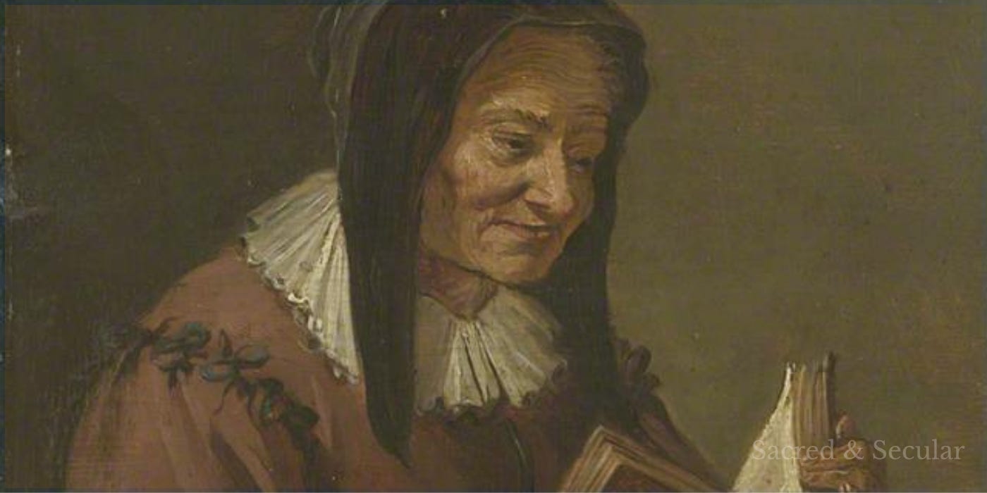 An elderly woman sits indoors reading from a large open book, likely a Bible. She leans forward attentively over the pages in a softly lit interior, creating a reflective scene of careful reading, listening and contemplation. An elderly woman sits indoors reading from a large open book, likely a Bible. She leans forward attentively over the pages in a softly lit interior, creating a reflective scene of careful reading, listening and contemplation.