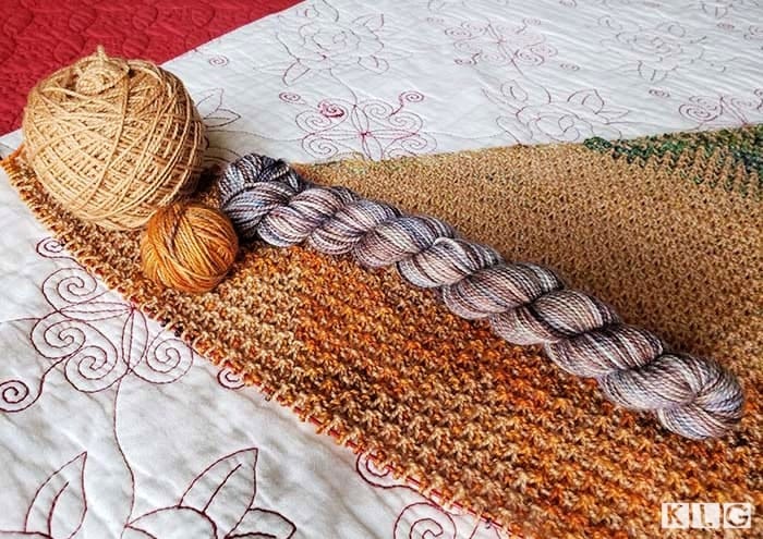 Koigu KPM 100% merino yarn and KPPM yarns in oranges, browns, greys and blues