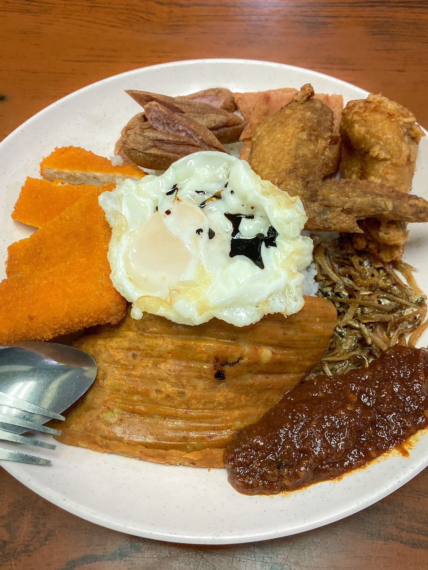 plate of nasi lemak with runny egg plate of nasi lemak with runny egg