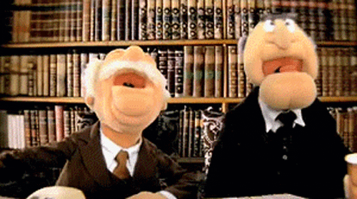 Gif of two puppets dressed like snooty older guys with facial hair laughing maniacally in front of a bookshelf.