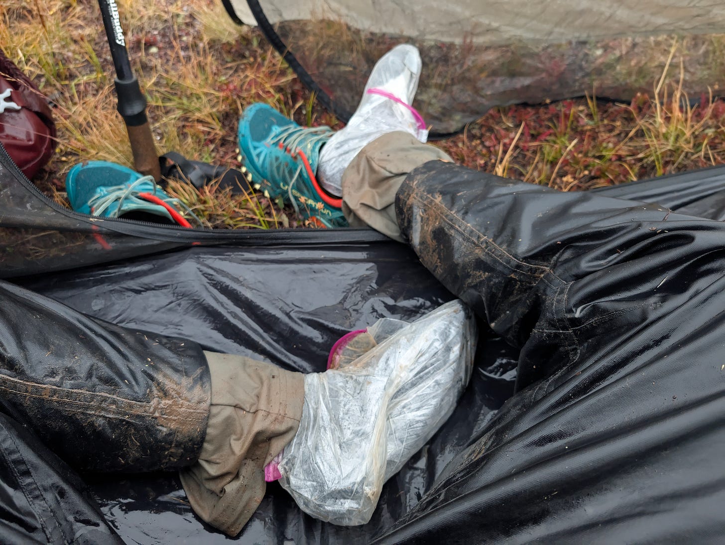 Mud-covered hiking pants and trail runners during a wet Colorado Trail descent, showing the toll of downhill hiking on feet, knees, and recovery routines