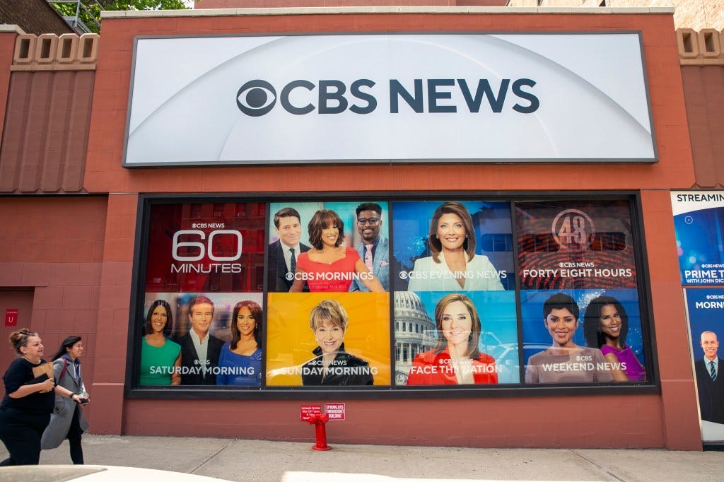 CBS News building exterior with show promotions.