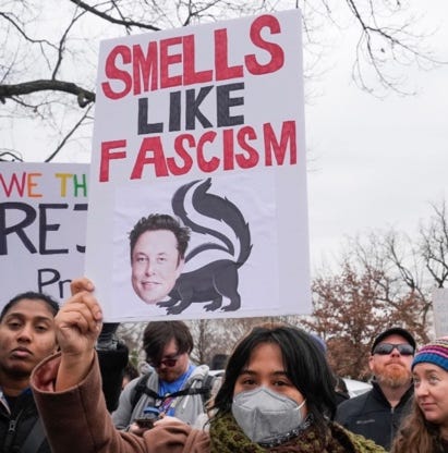 A group of people holding signs

AI-generated content may be incorrect.