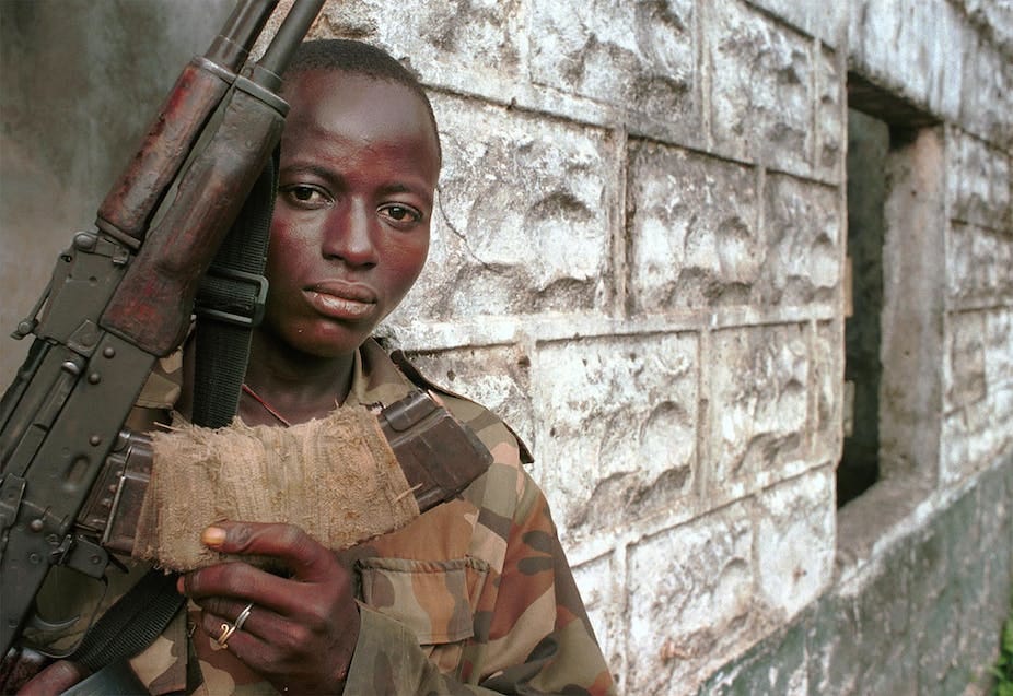 A young man brandishes his weapon