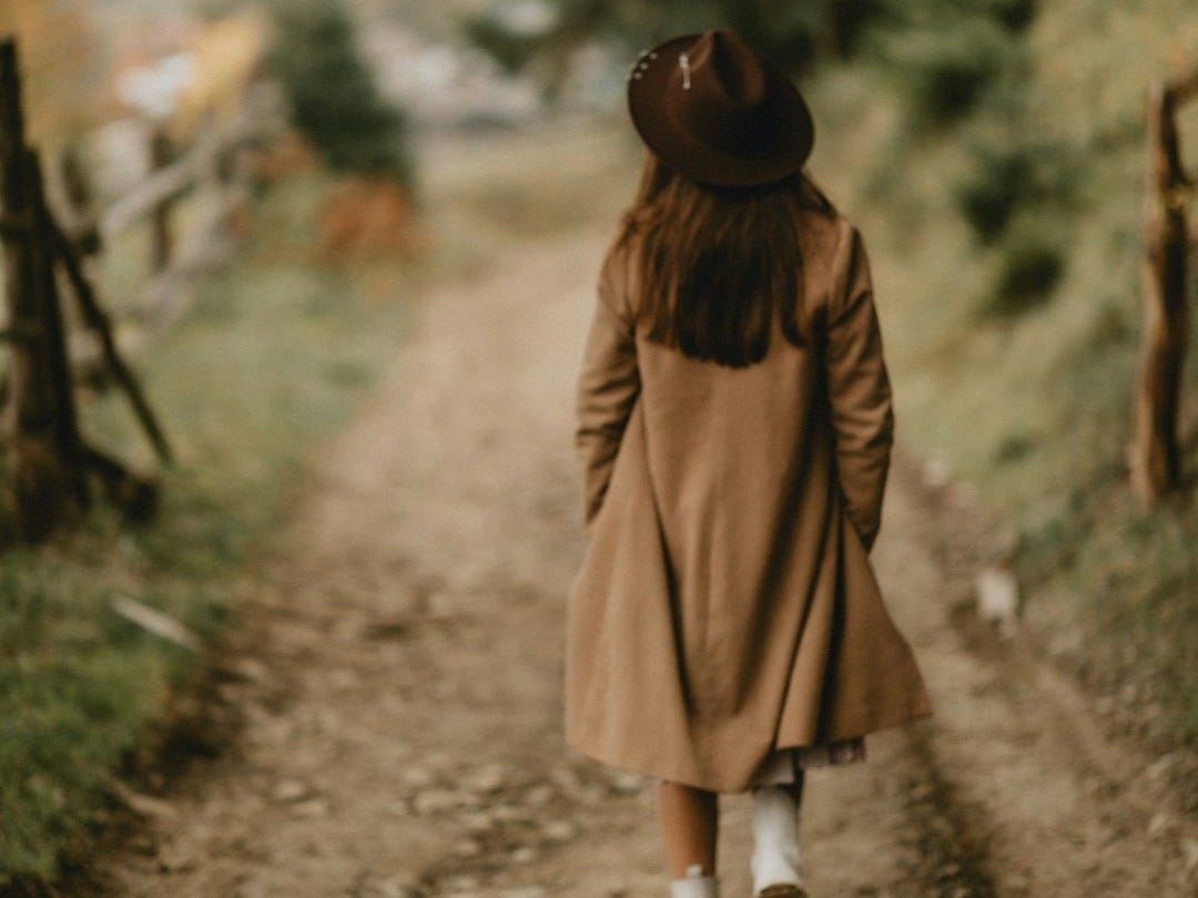 a person walking on a dirt road