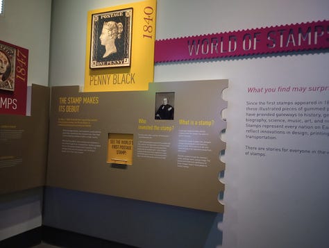 Left: Stamp featuring head of Queen Victoria, Middle, display with enlarged Penny Black Stamp, portrait of Rowland Hill and text Right, photo of Rowland Hill and text