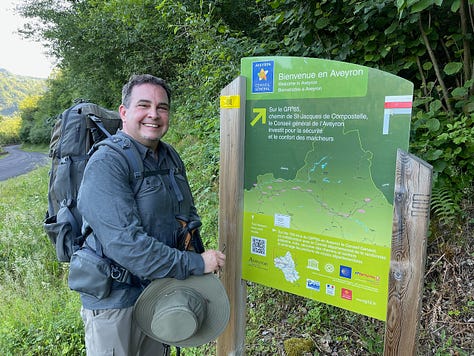 Jeffrey Keefer (at a Camino de Santiago sign in France, at my desk, and with a dolman on the Le Puy Camino)