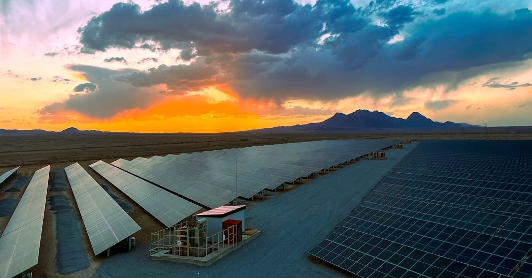 a large array of solar panels in a desert