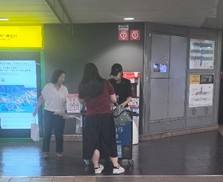 Think with your customer: temporary rush hour coffee pickup. The stand says: Metro Taipei × Louisa Coffee quick pickup cart