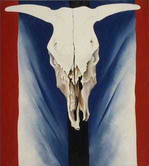 O'Keeffe's cow skull with horns open in a V, centered between vertical bands of black, blue and red