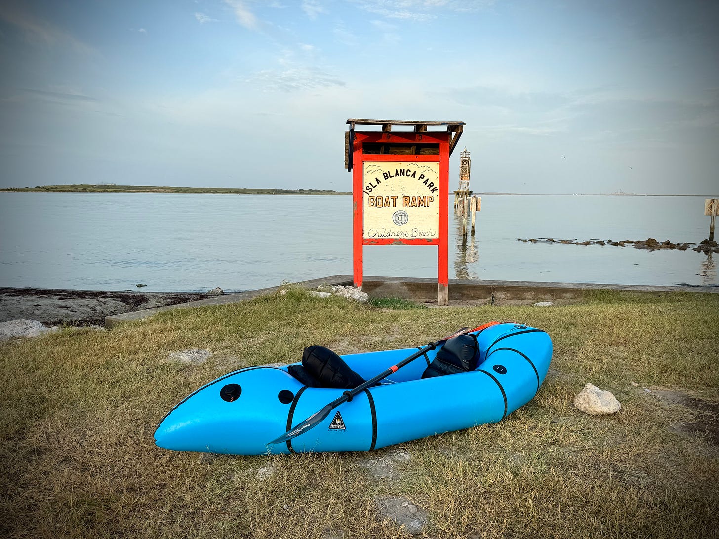 Blue packraft at put-in in Isla Blanca Park Blue packraft at put-in in Isla Blanca Park