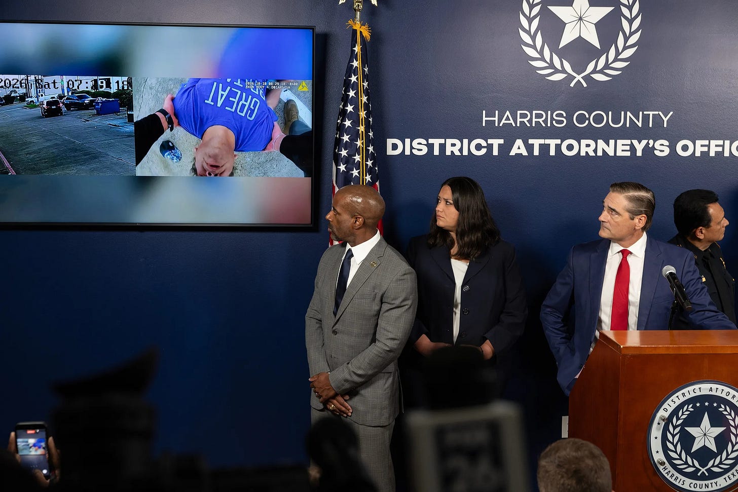 Harris County District Attorney Sean Teare and officials watch body camera footage during a press conference announcing a grand jury indictment of ICE agent Mario Alberto Morales on a charge of aggravated assault with a deadly weapon on Friday, Oct. 30, 2026, in Houston. The indictment alleges Morales drove his vehicle into Miguel Parra-Hernandez. (Texas Tribune photo by Antranik Tavitian) Harris County District Attorney Sean Teare and officials watch body camera footage during a press conference announcing a grand jury indictment of ICE agent Mario Alberto Morales on a charge of aggravated assault with a deadly weapon on Friday, Oct. 30, 2026, in Houston. The indictment alleges Morales drove his vehicle into Miguel Parra-Hernandez. (Texas Tribune photo by Antranik Tavitian)