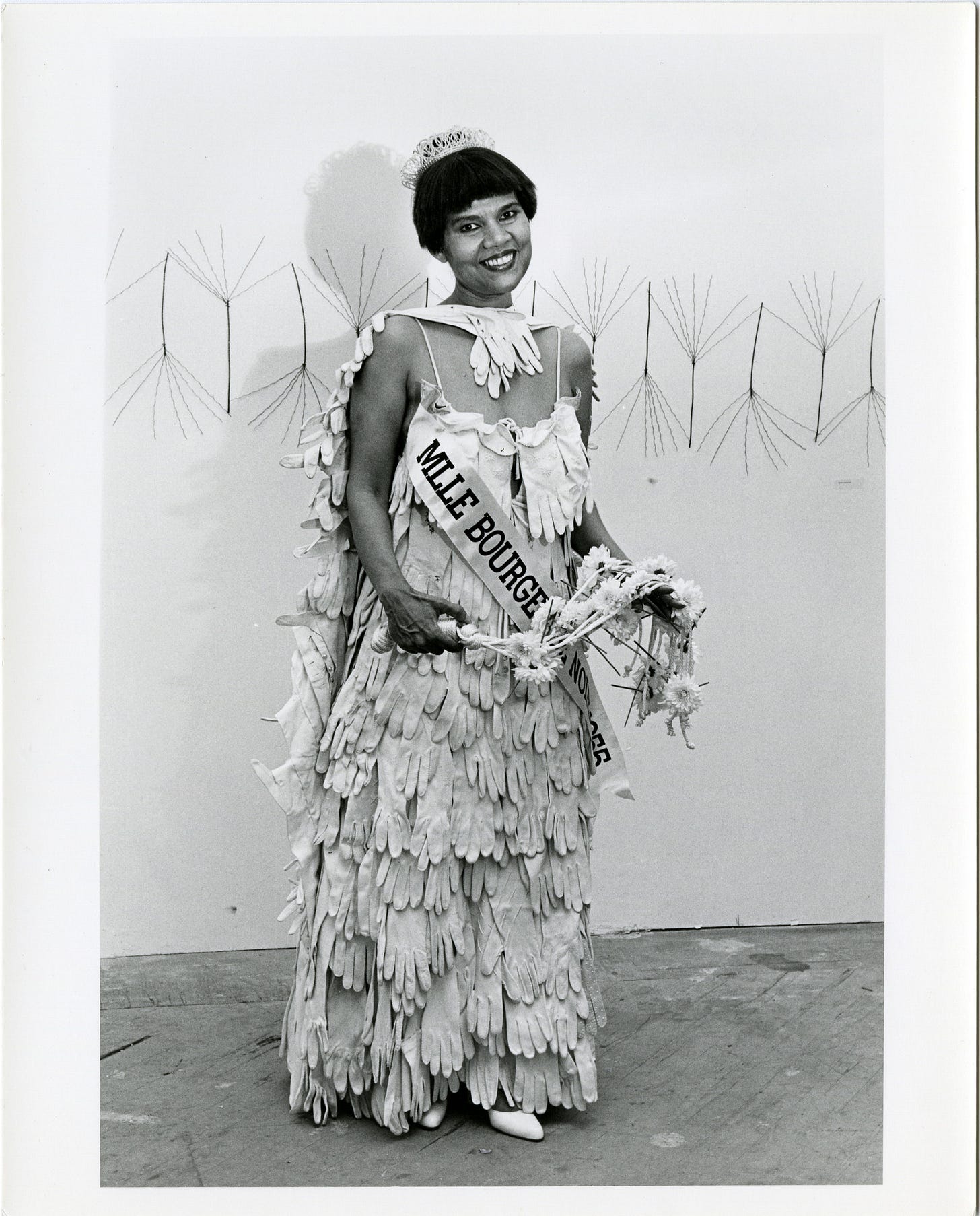 Lorraine O'Grady. *Untitled (Mlle Bourgeoise Noir)*. 1980. Four gelatin silver prints, each: 10 × 8 in. (25.4 × 20.3 cm). Performed at the opening of *Outlaw Aesthetics* (1980). Maren Hassinger’s *Palmettos* (1980) is visible behind O’Grady in the image on the right. Maren Hassinger. Photographs by Freda Leinwand. Schlesinger Library, Harvard Radcliffe Institute