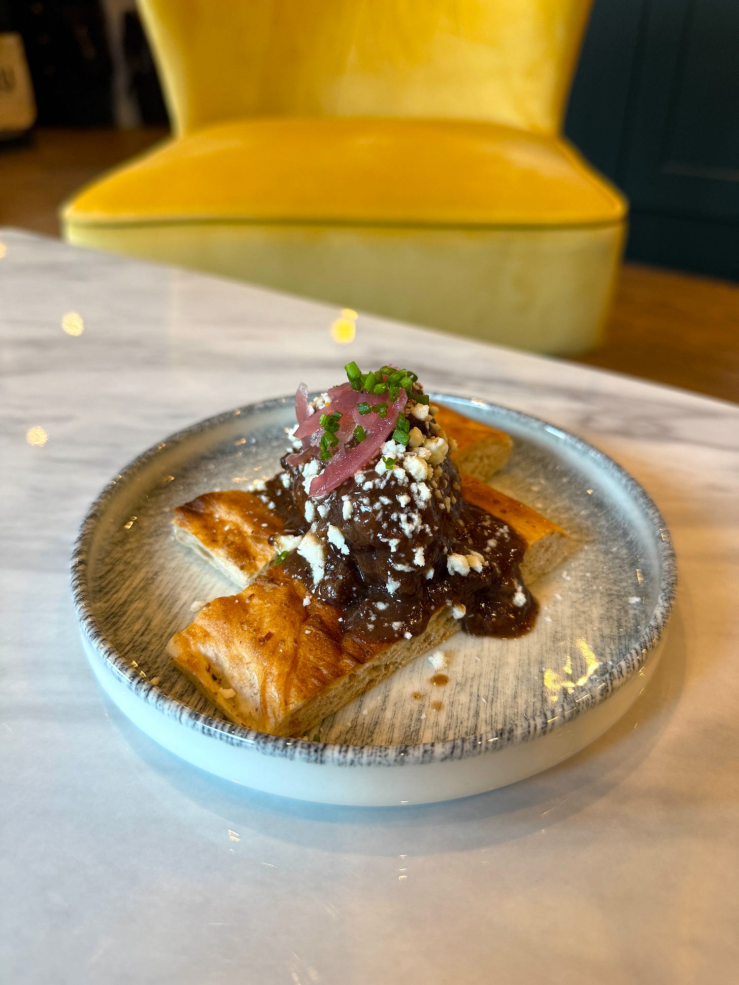 a plate of pork cheeks in a manchester wine bar