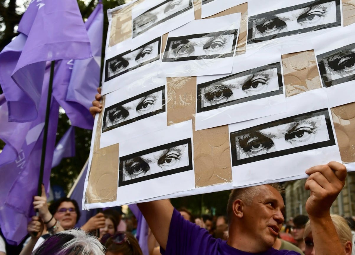 A person holding a poster with images of eyes

AI-generated content may be incorrect.