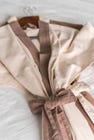 A dressing gown laid on a bed.