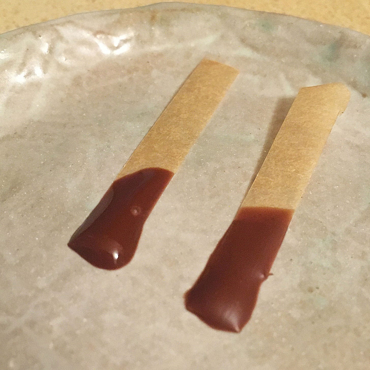dish with two samples of tempered and untempered chocolate dish with two samples of tempered and untempered chocolate