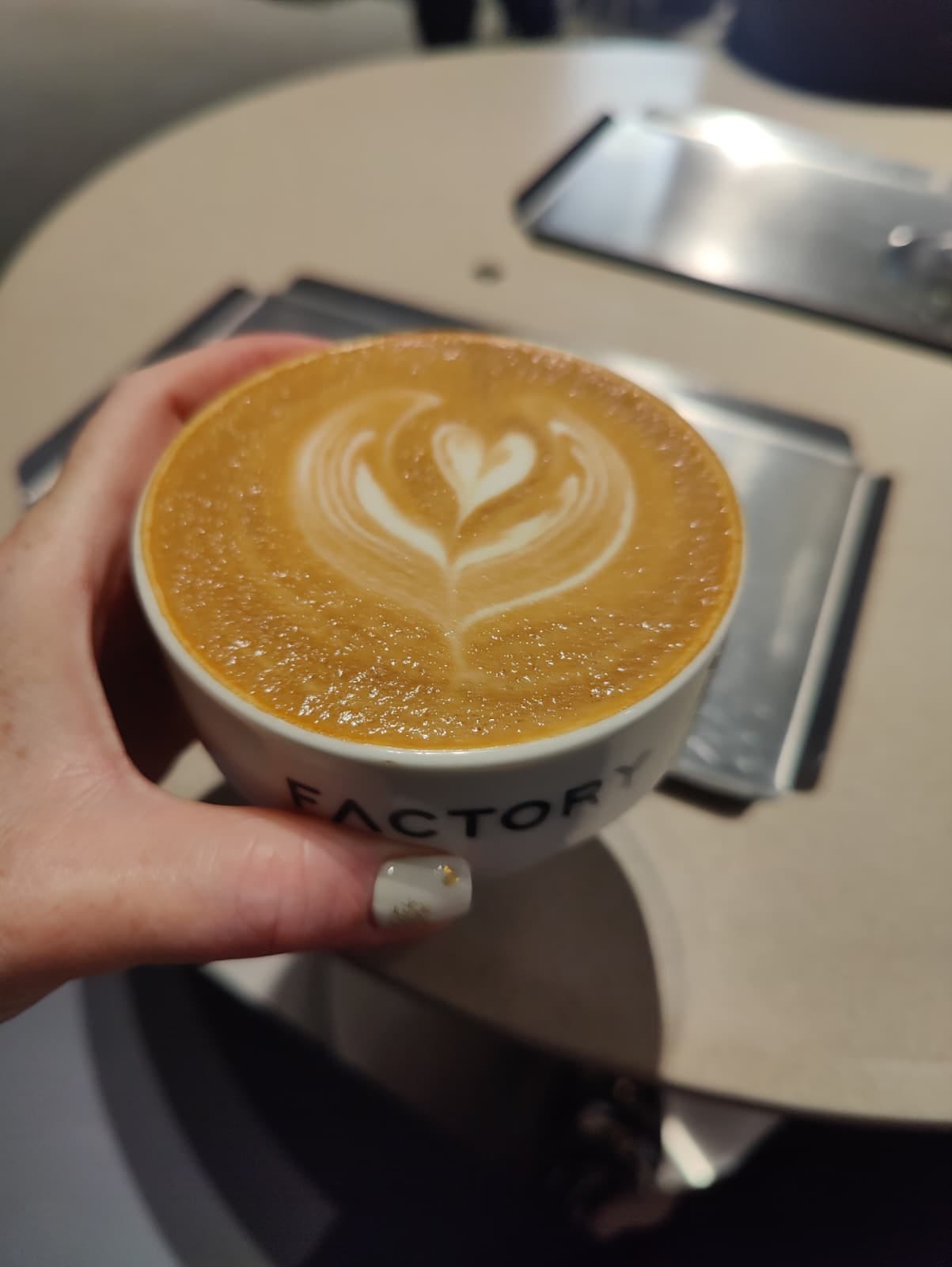 oat latte held in a hand