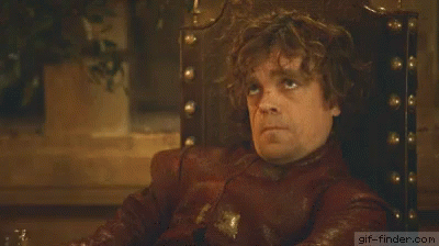 a man with curly hair is sitting in a chair and making a face . a man with curly hair is sitting in a chair and making a face .