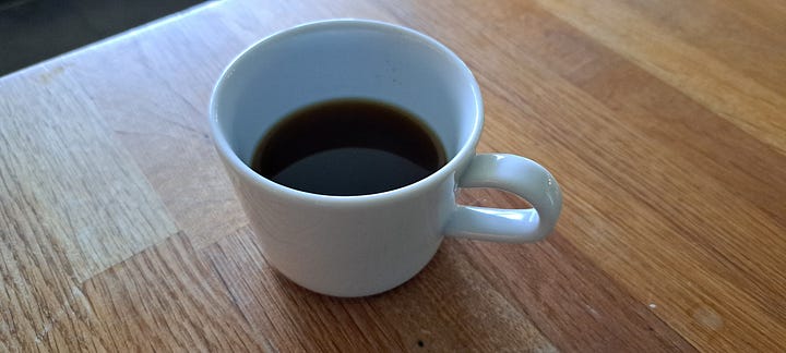 1. Chopped and roasted chunks of root on a plate. 2. Ground into a fine brown powder. 3. Brewing in a glass cafetiere. 4. Dark brown dandelion coffee in a white cup.