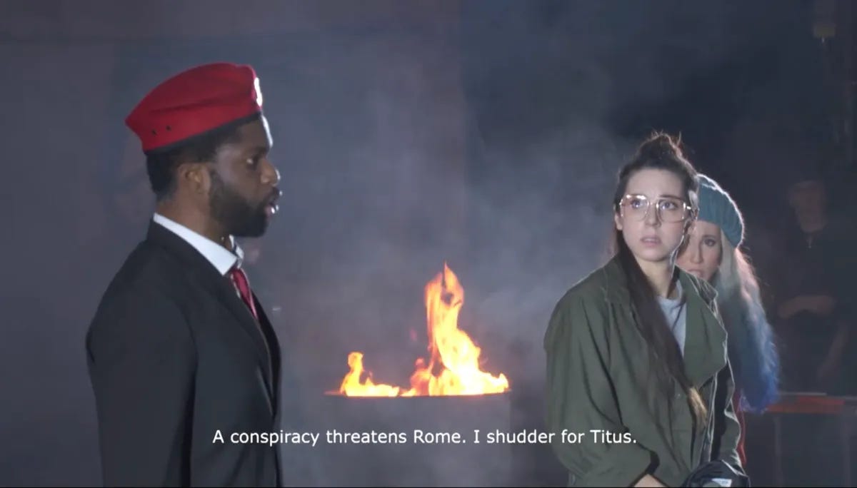 A screenshot from the stream of Milo Rau’s La clemenza di Tito with the subtitle: "A conspiracy threatens Rome. I shudder for Titus."